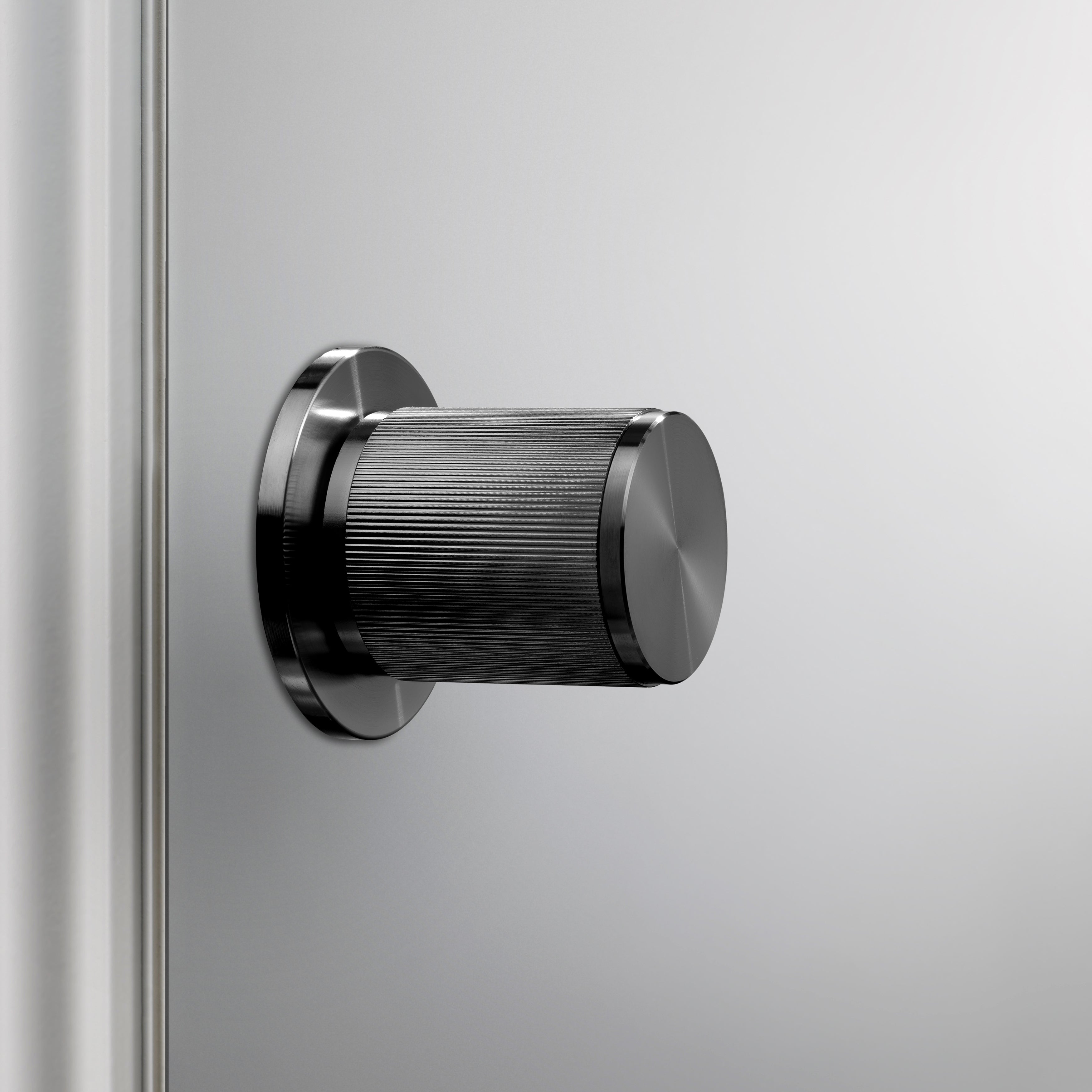 Exklusiv dörrknopp i gun metal med linjerat mönster.